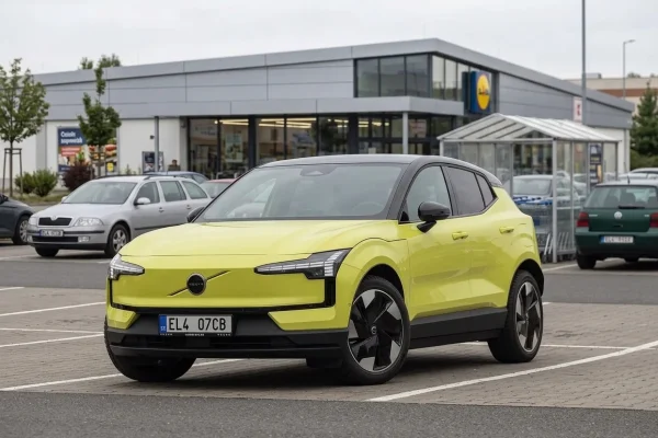 Volvo EX30 v žluté barvě zaparkované na parkovišti u supermarketu
