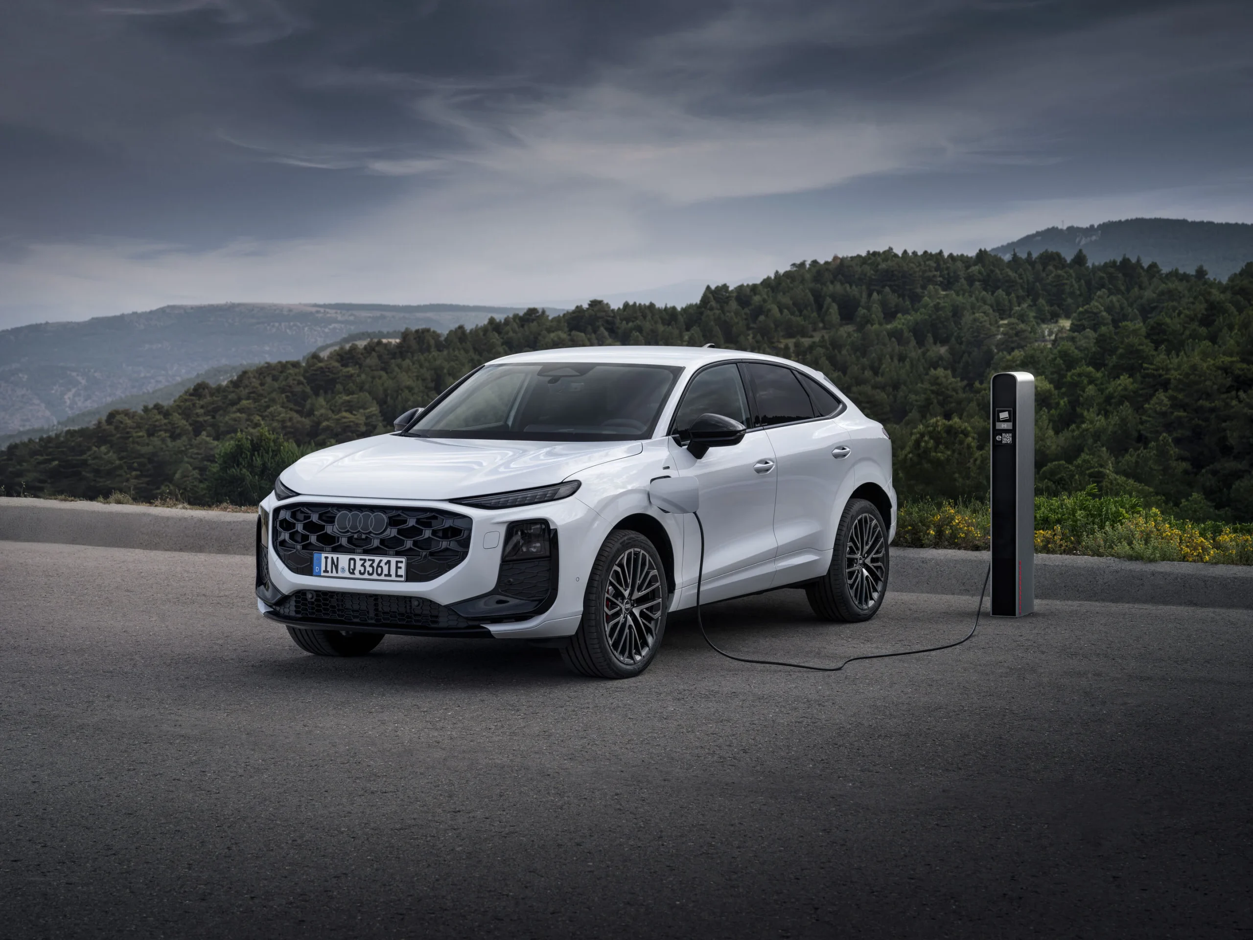 Audi Q3 Sportback zepředu a z boku u nabíjecího stojanu